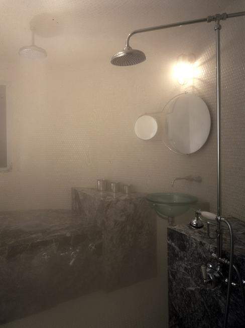 Steam enters the steam room via steamheads near the floor at either end of a marble bench.