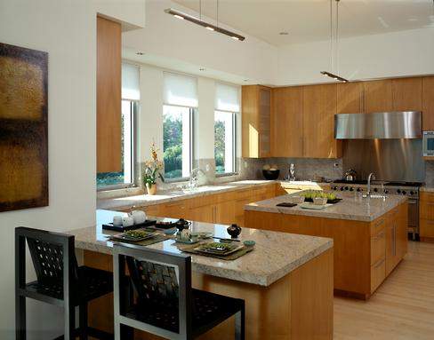 Geometric lines and stainless appliances are balanced by the organic look of maple cabinetry and granite countertops.