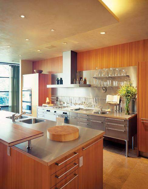 The backsplash of the kitchen’s stainless-steel food prep unit boasts display shelves and a rack for hanging spices and utensils.