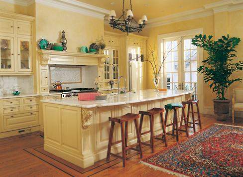Elegantly carved corbels repeat from the mantel over the cooktop to the center island. Concealed lighting makes the glass-fronted cabinets appear to float between the high ceiling and the countertops below.