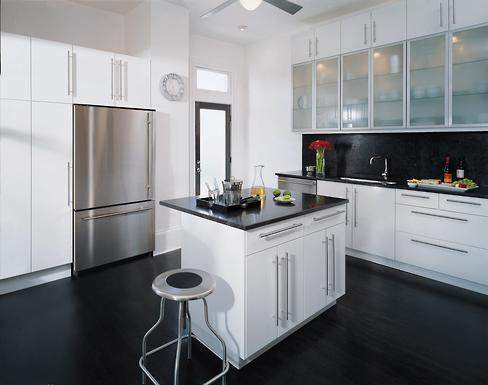 By removing a stairwell that led to the second floor, the homeowners now have a functional layout, which includes a central island. Oak floors were stained on-site with a deep ebony finish.
