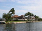 Marco Island has canals that lead to the Gulf of Mexico and to the Marco River.  Direct access means you do not need to pass under a bridge to get out to open water, Indirect means that you need to pass under one or more bridges to get to open water.