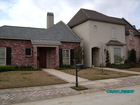 This is an example of a Baton Rouge home that is built in the popular French style that is prevelant through out the city.  It is caracterized by a mix of stucco and brick on the exterior and accented with gas laterns, old beams and materials.