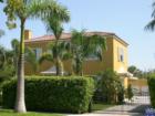 Old, historic style home in Flamingo Park, West Palm Beach.. with typical detached garage in background.