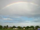 Ironic rainbow just before welcome yet another hurricane. Notice windows with plywood and shutters across the lake.