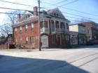 Building on one of the four corners in the center of town, used as apartments and is directly across from Madlin Hotel