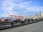 "Drive-By Photo" from the Alaskan Way Viaduct of the Port of Seattle with it's massive orange cranes for loading and unloading containers from ships.  