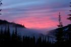Sunset in Sun Peaks.  Photographed from Woodhaven Townhomes, overlooking Sun Peaks Village hidden in evening mist.  Photograph by Richard Anderson.