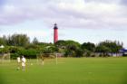 Playing soccer in front of lighthouse