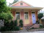 New Orleans Uptown cottages feature some of the following: nice porches, full length windows, shutters, high ceilings, wood floors, fireplaces, gingerbread woodwork, wrought iron fences, in a tree shaded yard with sub tropical plant species.  