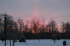 The sun rises over Locust Curve Park the morning after five-inches of snow fell.