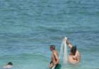 Throwing net along the beach at Cement City