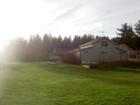 A rambler on a 5 acre lot with a barn and 2 car garage.