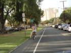 Surfer riding his bike to catch some Waikiki waves.