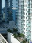 Close up view reveals sunbathers, onlookers and mirrored buildings.