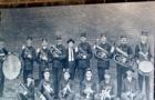 Outdoor Photo Display Along an Old Brick Wall in Celina Texas.  Photo of Soliders Posing Along Brick Wall
