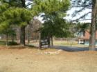 Sign for the Owl's Nest Family Club in Sanford, NC.  You can see the tennis courts in the background.