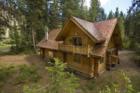 Some people call this a cabin others call it a luxury home. This house is a handhewn log cabin on the Wenatchee River near Plain. It has a copper roof and a custom slate fireplace.