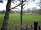 View of the Park area in the Knolls of Huntington.  Greenspace / detention area equipped with very nice park benches.