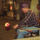 A craftsman blows glass by hand at Blenko Glass in Milton, WV.