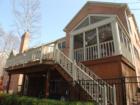 Rear view of Bel Air home showcasing its deck and screened porch.  BranchSells.com