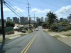  Mooheau Ave. going down towards Kapahulu Ave. with Waikiki buildings in background. You can see the Prudential Location's building, Hawaii's #1 real estate firm's building, at the bottom of the hill on the left side. 
      