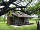Ms. Eva's historic log cabin in little elm tx now sits in Beard Park on the shores of Lake Lewisville.  Little Elm tx homes for sale, Lake View Homes for Sale.