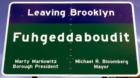 Leaving Brooklyn: "Fuhgeddaboudit" 
      Sign posted on Belt Parkway before you enter Queens on the Brooklyn side near Exit 15