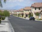 Richmond @ Rhodes Ranch is a community of courtyard homes located in the southwestern foothills of the Las Vegas valley.  View of north mountains & Queensridge Luxury High Rise Condos in backdrop.