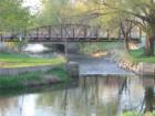 The walking path around Lake Nokomis crosses over the winding Minnehaha Creek via this wooden bridge.