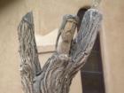 Carved figure in front of Cerrillos church