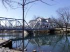 Finley River and Finley River Bridge in Ozark, Missouri, with the old mill in the background.