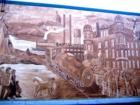 Located on the side of a building on 5th avenue S, in South St. Paul, this 18 by 84 foot mural depicts South St. Paul's 119 year history.  Painted by local artist Robert Zins.