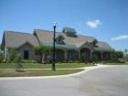 The Plantation Lakes clubhouse features a full kitchen, dining area, living room style gathering room with fireplace, fully stocked fitness gym, tv viewing room and great screened in picnic area!