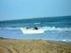 Fishermen beaching their dory after setting their net