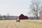 A farmer on tractor preparing his field for planting on farm in South Glastonbury, CT