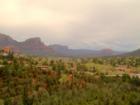 A Spring storm brings a softer focus to the natural beauty of the Red Rocks and new green foliage in Uptown Sedona. You can see Elephant Rock to the left, and Cathedral Rock to the right in the distance.