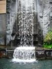 Water fall on the side of a downtown office building.