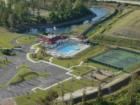 Aerial view of Bluffs clubhouse, swimming pool, tennis courts & children's play area.
