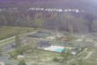 Aerial view of the clubhouse, swimming pool, tennis courts & children's play area.