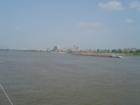 Picture of Memphis skyline with the Pyramid on the left. Taken on a Mississippi River boat cruise. See the barge on the river.