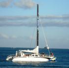 High tech sail boat heading out of the harbor.