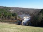 Falls Lake provides Raleigh's drinking water.  This is a view of the tailrace, a popular fishing area, from the dam breast. The bridge is Falls of the Neuse Road, scheduled to be widened to serve developments north of the dam.