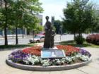 Statue of Abigail Adams with summer flowers located across the street from Quincy City Hall.