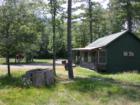 Bud Nelson's "Island Oasis" bar near the Madeline Island airport.  Note the huge tree stump in the front yard!