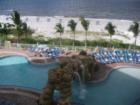Resort style pool with water feature and poolside food/beveridge service.