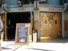 An ornate Oriental-themed door and a uniformed doorman greets you at the entrance of Grauman's Chinese Theater.