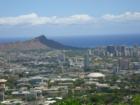 This beautiful view of Downtown Honolulu is taken from along Tantalus Drive in the Ko'olau Mountain Range above the city of Honolulu.  The round building in the center is Stan Sherrif Center home of the U of H basketball and volleyball teams.