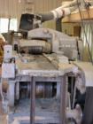 This machine is capable of planing four sides of a piece of wood in one pass.