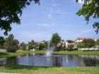 Lake Fountain in Town Place Club Villas that is visible during the day and early evening. 